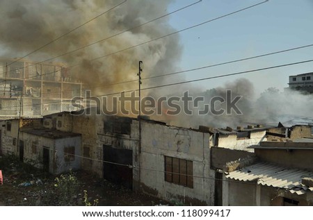 KARACHI, PAKISTAN - NOV 08: Smoke rise from a godown that caught fire due to electric short circuit in North Nazimabad area on  November 08, 2012 in Karachi.
