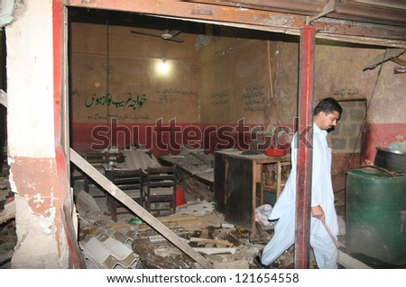 KARACHI, PAKISTAN - DEC 12: View of destruction after bomb blast in a tea shop, at  Landhi area on December 12, 2012 Wednesday,. Two people killed including one police official,