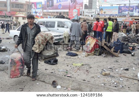 QUETTA, PAKISTAN - JAN 10: People gather at site after bomb blast at Bacha Khan Chowk  on January 10, 2013 in Quetta. At least eleven people were killed and more than 50 injured.