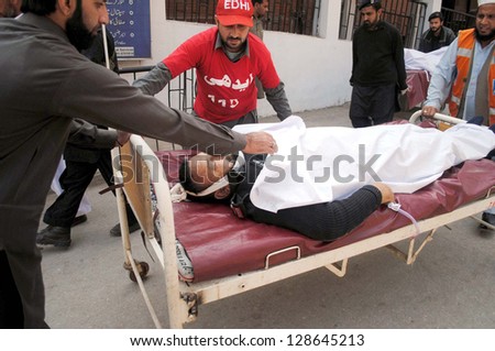 PESHAWAR, PAKISTAN - FEB 18: Victim of political agent office bombs blast being shifted at Lady Reading Hospital for treatment, on February 18, 2013 in Peshawar.  Atleast five persons were killed