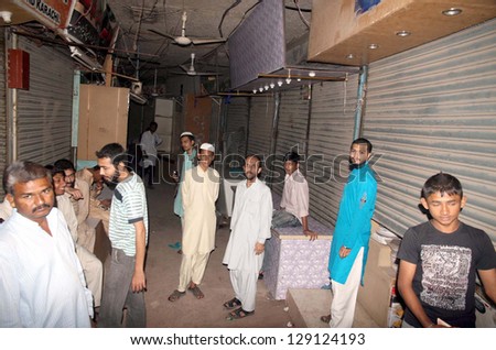 KARACHI, PAKISTAN - FEB 22: Shops keepers gather in market after robbery in several shops at Bazar-e-Faisal at Karimabad area on February 22, 2013 in Karachi.
