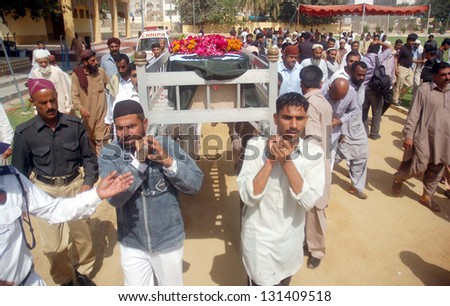 KARACHI, PAKISTAN - MAR 12: People carry coffin of Policeman Gul Sher, who was gunned down by unidentified persons during performing his duty at Gulshan Ghazi area on March 12, 2013 in Karachi.