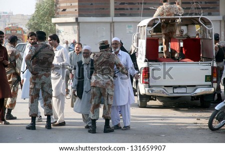 KARACHI,PAKISTAN - MAR 15: Rangers officials cordon off the locality during targeted  operation against defunct organizations at Hijrat Colony area on March 15, 2013 in Karachi.