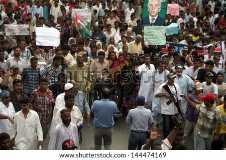 KARACHI, PAKISTAN - JUL 01: Residents of Lyari are protesting against operations conducted by rangers and security personnel in their area during demonstration on July 01, 2013 in Karachi.