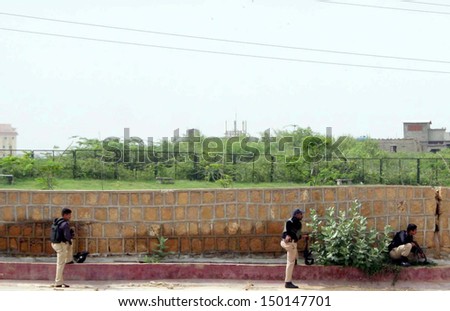 KARACHI, PAKISTAN - AUG 15: Police and rangers officials cordon-off the area during  targeted search operation against criminals near Safari Park in the Madu Goth area on August 15, 2013 in Karachi.