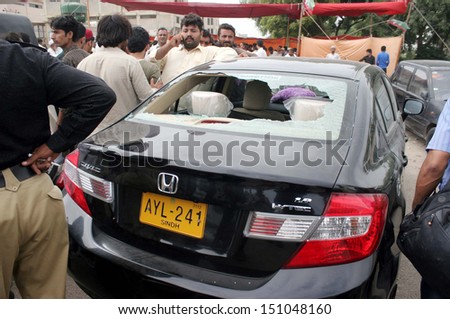 KARACHI, PAKISTAN - AUG 22: Clash between two political groups outside a polling station at political group camp during by-election for NA-254 at Korangi area on August 22, 2013 in Karachi.