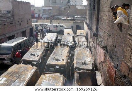 KARACHI, PAKISTAN - JAN 01: View of burnt ambulances which got fire due to unknown reason while parking in premises of Old Sabzi Mandi area office of Edhi Welfare on January 01, 2014 in Karachi.