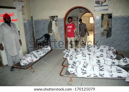 KARACHI, PAKISTAN - JAN 07: Slaughtered dead bodies of six people found in the premises of Ayub Shah Mausoleum, at Gulshan-e-Maymar area limits, at Edhi Home Mortuary on January 07, 2014 in Karachi.