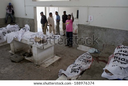KARACHI, PAKISTAN - APR 24: Dead bodies of people killed in a suicide blast in the Old  Sabzi Mandi area of Karachi left four people including police inspector dead on April 24, 2014 in Karachi.