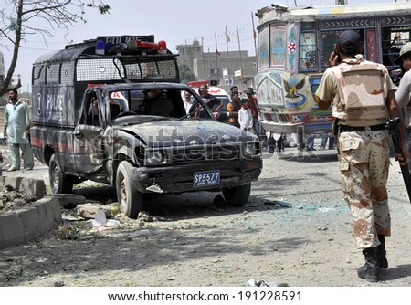 KARACHI, PAKISTAN - MAY 06: Security officials are gathering at venue after bomb attack on police van caused two policemen injured including officer Farooq, at North Karachi area on  May 06, 2014.