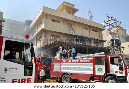 KARACHI, PAKISTAN - MAY 19: Fire fighters busy in extinguishing fire at factory that caught fire due to electric short circuit, after fire broken out incident Baldia Town on May 19, 2014 in Karachi.