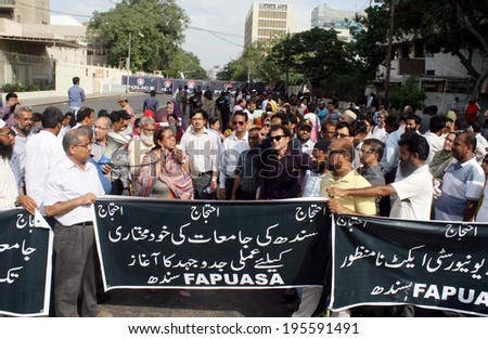 KARACHI, PAKISTAN - MAY 29: Members of Federation of All Pakistan Universities  Academic Staff Associations (FAPUASA) chant slogans against Sindh Universities Act on May 29, 2014 in Karachi.