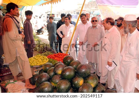 PESHAWAR, PAKISTAN - JUL 03: Khyber Pakhtunkhwa Minister for Food Department,  visit at stall after inauguration Ramadan Bazar during the Holy month of Ramadan on July 03, 2014 in Peshawar.