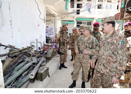 MIRANSHAH, PAKISTAN - JUL 07: Chief of Army Staff, General Raheel Sharif being shown different weapons and equipment recovered from terrorists during his visit in Miranshah Bazar on July 07, 2014.