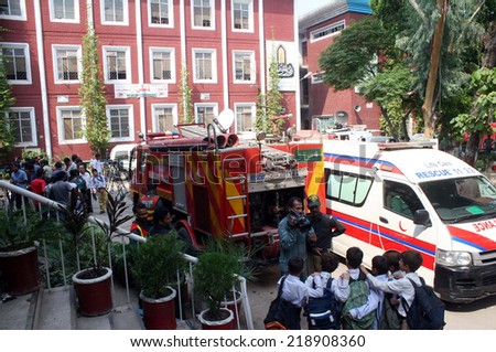 LAHORE, PAKISTAN - SEP 22: Fire fighters busy in extinguishing fire at Election Commission of Pakistan (ECP) building basement that caught fire due to unknown reason, in Lahore on September 22, 2014.