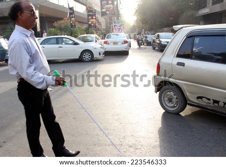 KARACHI, PAKISTAN - OCT 14: Disable Blind person pass through a road on occasion of the \