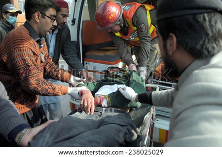 PESHAWAR, PAKISTAN - DEC 16: Victims of militants attacked an Army Public School  situated on Warsak Road, being shifted for treatment at local hospital on December 16, 2014.