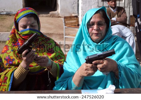 PESHAWAR, PAKISTAN - JAN 27 Teachers of Frontier College for Women begin briefed  about firearms training during special gun training sessions for female teachers on January 27, 2015 in Peshawar.