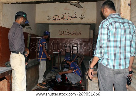 KARACHI, PAKISTAN - APR 13: Security staffs cordon off the venue after assassination of three Bangladeshis at a tea stall located in Korangi No. 2 on April 13, 2015 in Karachi.
