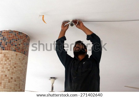 KARACHI, PAKISTAN - APR 21: Technicians are installing CCTV cameras at a polling station for the By Election of NA-246, at a school near Gulberg on April 21, 2015 in Karachi.