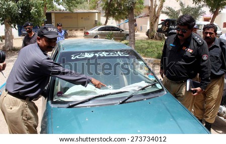 KARACHI, PAKISTAN - APR 29: Police standing near vehicle of Doctor Syed Waheed-ur-Rehman assistant professor teaching at the Karachi University, who was gunned down on April 29, 2015 in Karachi.