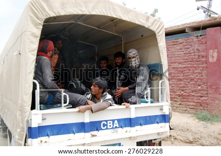 CHAMAN, PAKISTAN - MAY 07: Pakistani security carry Afghan prisoners sit in the truck to handing over Afghan authority move toward Friendship gate on Pak- Afghan border on May 07, 2015 in Chaman.