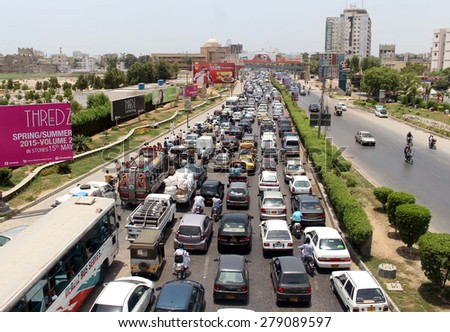 KARACHI, PAKISTAN - MAY 18: A large numbers of vehicles stuck in traffic jam during  VVIP movement at Shahrah-e-Faisal on May 18, 2015 in Karachi.