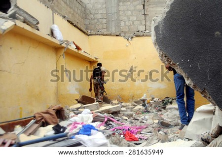 KARACHI, PAKISTAN - MAY 26: Security officials inspect the site after a targeted operation conducted in Orangi Town area on May 26, 2015 in Karachi.