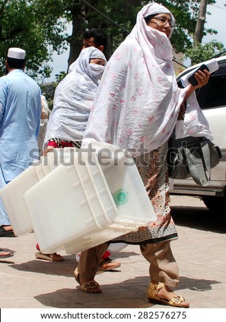 PESHAWAR, PAKISTAN - MAY 29:  Presiding staffs carrying election material towards  polling stations as the Local Government Elections are being held on 30th May in KPK, on May 29, 2015 in Peshawar