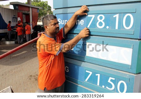 KARACHI, PAKISTAN - JUN 01: Fuel pump employee changing fuel prices after prices \
increases on petroleum products, in Karachi on Monday, June 01, 2015 in Karachi.