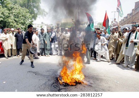 PESHAWAR, PAKISTAN - JUN 02: Activists of People Party (PPP) burn tyres as they are \
protesting against rigging in local government election during demonstration on June 02, 2015 in Peshawar.
