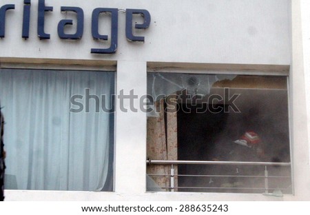 LAHORE, PAKISTAN - JUN 18: Fire fighters extinguishing from burning building after fire  broken out incident at private hotel building located at Davis road on June 18, 2015 in Lahore.