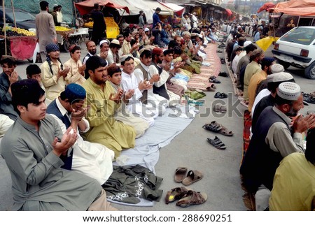 QUETTA, PAKISTAN - JUN 19: Muslims praying after offering  Jumma  on the occasion of first Friday of holy month of Ramzan-ul-Mubarak, at Meezan Chowk on June 19, 2015 in Quetta.