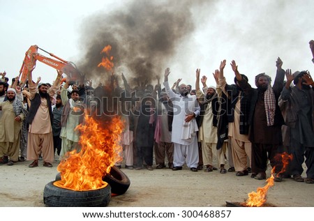 CHAMAN, PAKISTAN - JUL 27: Members of M.A.T and Tribal Elders burn tyres and block road as they are protesting against burn tyres handedness of Chaman Custom officials on July 27, 2015 in Chaman.