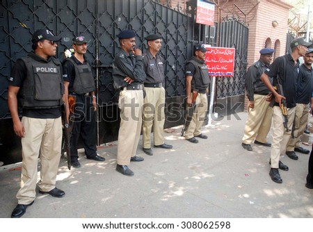 KARACHI, PAKISTAN - AUG 20: Police staffs standing alert after clash and torture by security staffs of a private hospital on journalists while coverage of news on August 20, 2015 in Karachi.