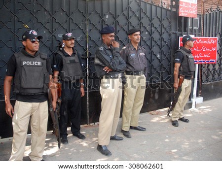 KARACHI, PAKISTAN - AUG 20: Police staffs standing alert after clash and torture by security staffs of a private hospital on journalists while coverage of news on August 20, 2015 in Karachi.