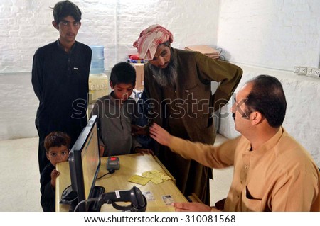 QUETTA, PAKISTAN - AUG 26: Afghan people are at UNCHR office located in Quetta as Afghan refugees are going back to their homeland Afghanistan after spending many years on August 26, 2015 in Quetta.