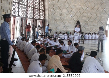 KARACHI, PAKISTAN - SEP 11: Pakistan Navy personnel are reciting Holy Quran for the departed soul of founder of Pakistan on the occasion of 67th death anniversary on September 11, 2015 in Karachi.