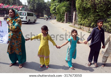 LAHORE, PAKISTAN - SEP 17: Residents of District Bahawalnagar chant slogans against high handedness of their police officials during protest demonstration on September 17, 2015 in Lahore.