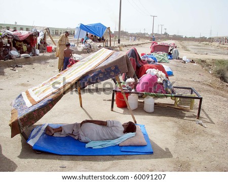 HYDERABAD, PAKISTAN - AUG 30: A flood-affected person rests under a makeshift canopy at a relief camp on August 30, 2010 in Hyderabad.