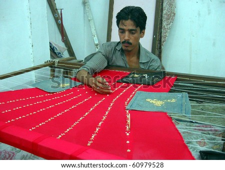 KARACHI, PAKISTAN - SEPT 7: Artisan prepares hand embroidery to earn his livelihood to support his family, at workshop ahead of the Eid-ul-Fitar in Karachi on September 07, 2010