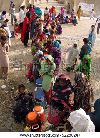 KARACHI, PAKISTAN, SEPT 30: Flood affected people with their drinking water coolers  stand in queues as they are waiting for their turn to get drinking water at water tank at flood affectees relief on September 30, 2010 in Karachi, Pakistan.