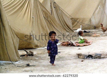 KARACHI, PAKISTAN, SEPT 30: Flood affected children play at their make-shift tent houses  at flood affectees relief camp established at Hawks bay area on September 30, 2010 in Karachi, Pakistan.