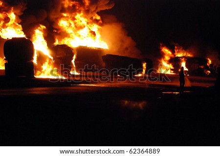 SHIKARPUR, PAKISTAN, OCT 01: Fire flames rise from burning Afghanistan-bound NATO oil tankers following armed attack on October 1, 2010 in Shikarpur, Pakistan. Suspected militants were set ablaze