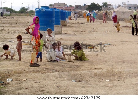 KARACHI, PAKISTAN, OCT 03: Flood affectees children play outside their make-shift tent  houses at relief camp established at Hawks bay area on October 3, 2010 in Karachi, Pakistan.