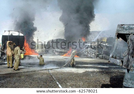 QUETTA, PAKISTAN - OCT 06: Firefighters extinguish fire of burning NATO oil tankers following armed attack on October 06, 2010 in Quetta, Pakistan