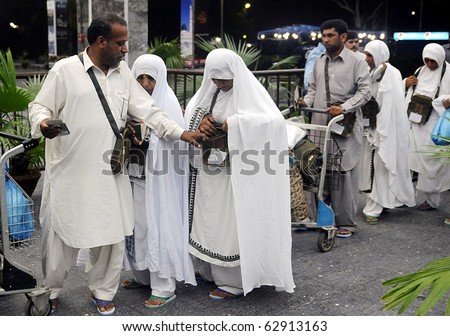 KARACHI, PAKISTAN - OCT 11: Pakistani Muslims stand in queue as they depart for the Annual Hajj pilgrimage in Saudi Arabia, on October 11, 2010 at Karachi, Pakistan.