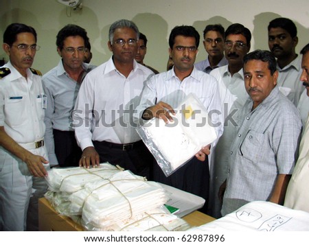 KARACHI, PAKISTAN - OCT 13: Customs officials show seized packets of two-hundred and twenty-six kilograms Cocaine Powder during press conference at Custom House on October 13, 2010 in Karachi, Pakistan.