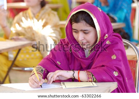 SUKKUR, PAKISTAN - OCT 17: Students solve papers during entry test for admission in Ghulam Mohammad Mahar Medical College held on October 17, 2010 in Sukkur.
