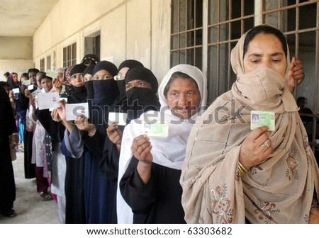 KARACHI, PAKISTAN - OCT 17: Women hold their National Identity Cards (NICs) to cast their votes at a polling station during by-election for PS-94 at Orangi Town on October 17, 2010 in Karachi.